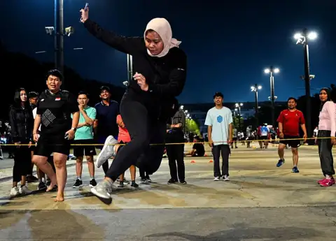 EVERY FRIDAY NIGHT, HUNDREDS OF JAKARTA ADULTS DITCH HAPPY HOUR TO PLAY JUMP ROPE IN A PARKING LOT